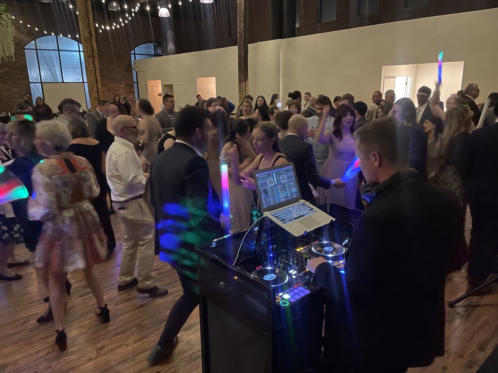 DJA performing to a crowded dance floor.